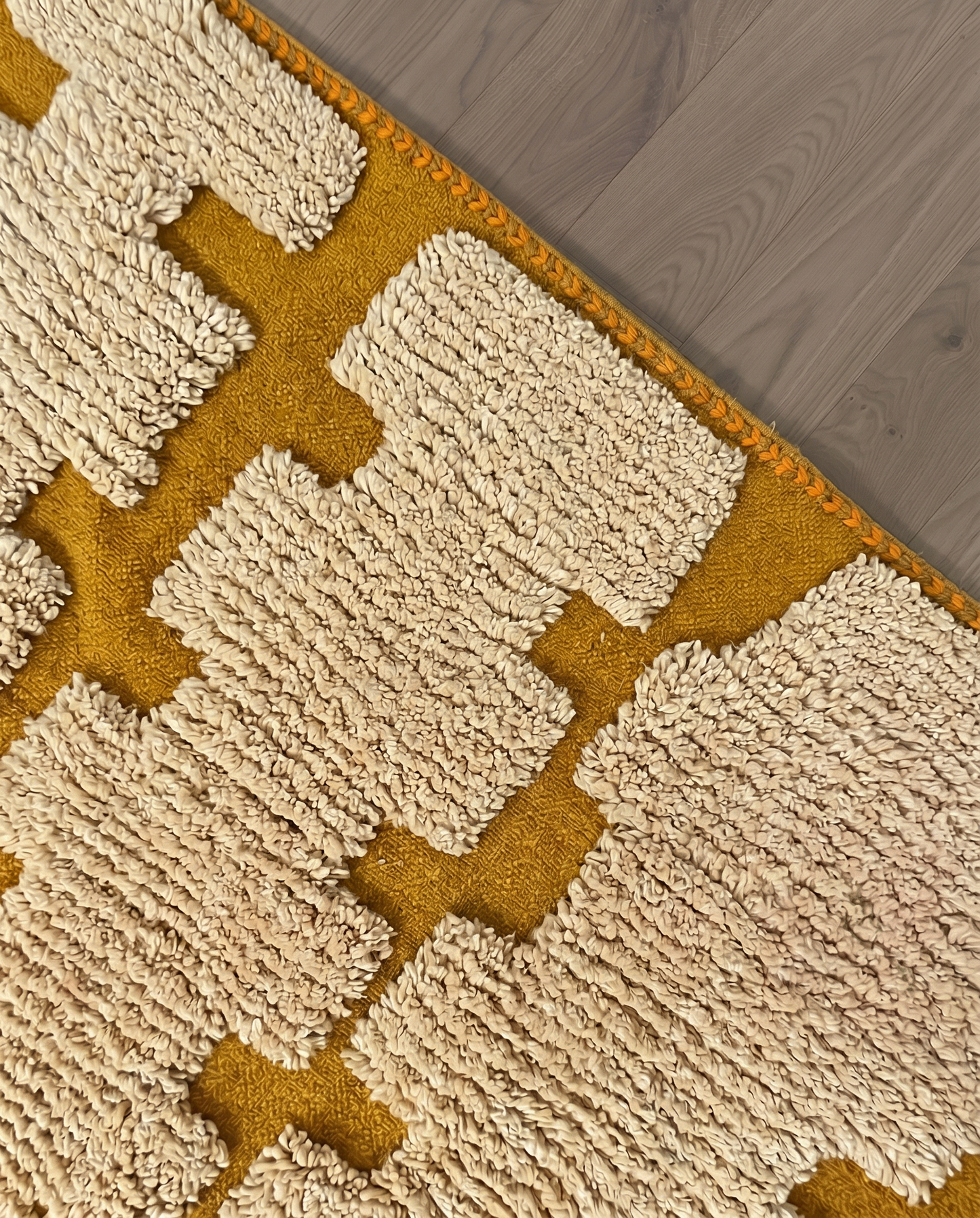 ARWA Beni Ourain mustard stepped columns Moroccan rug close-up of hand-tied fringe and kilim band detail, by NURA