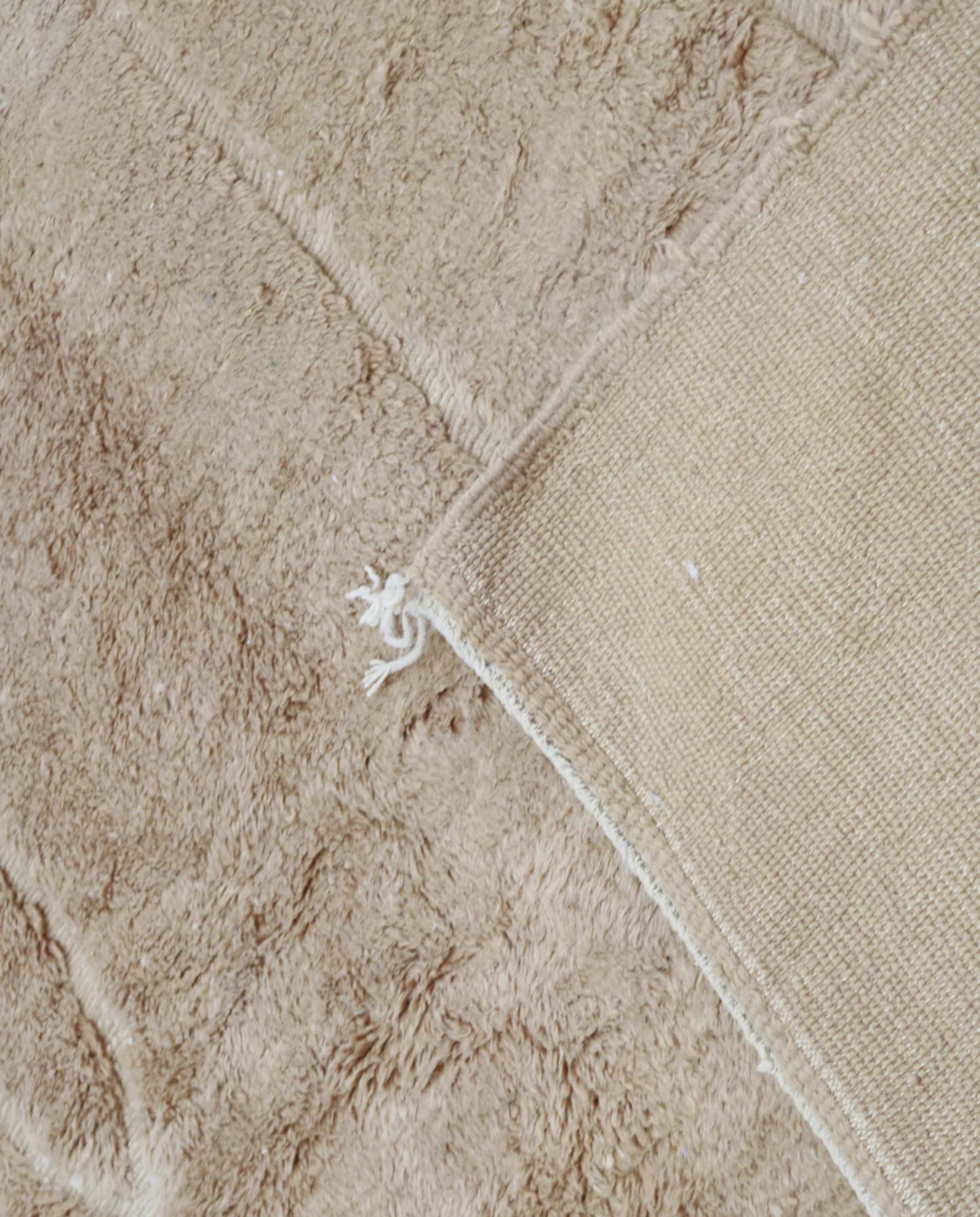 ASSIA Mrirt camel solid carved field Moroccan rug back view showing traditional handwoven construction 2, by NURA