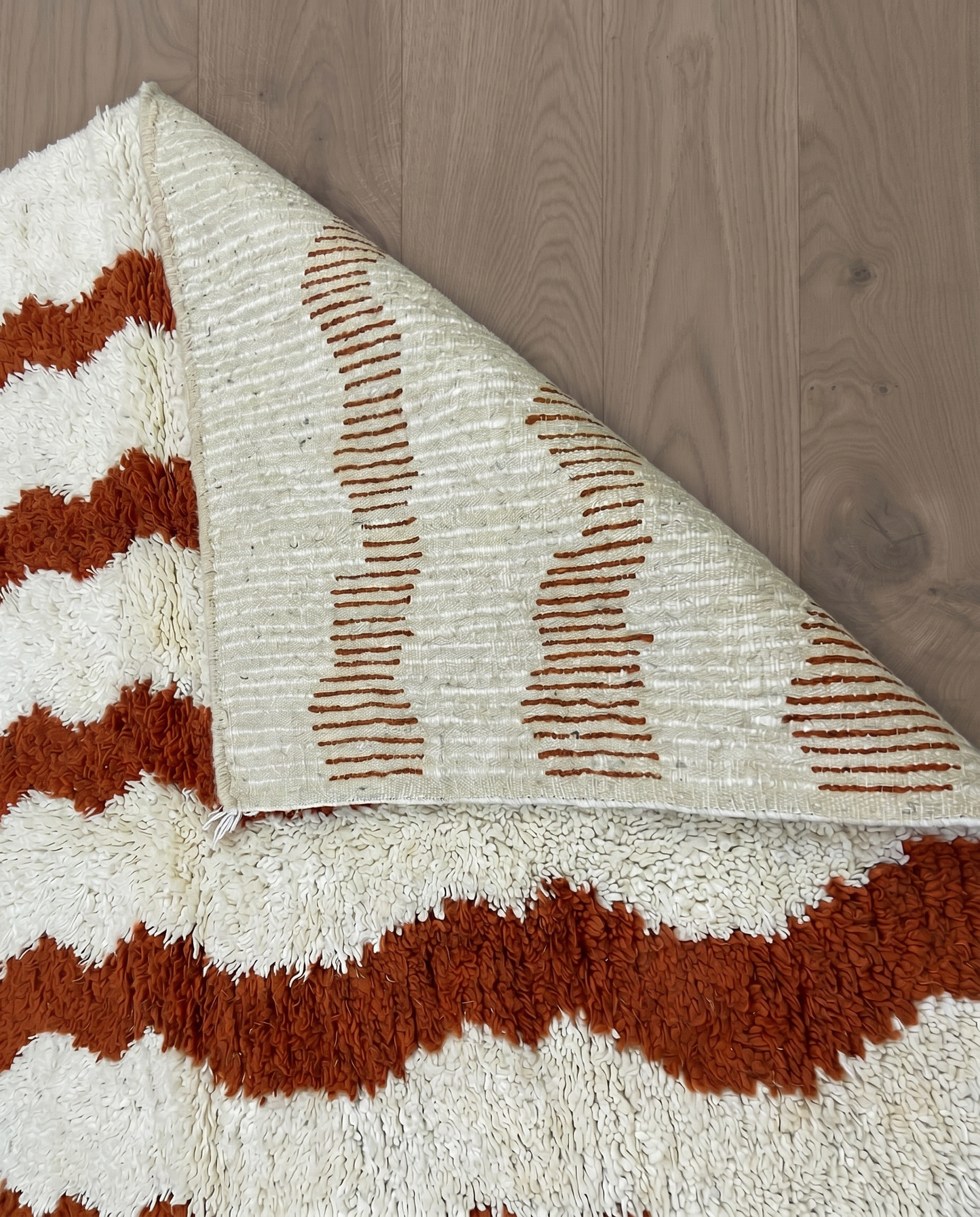 AZIZA Beni Ourain cream wavy stripes Moroccan rug back view showing traditional handwoven construction, by NURA