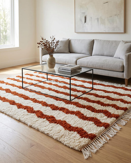 Plush Beni Ourain Moroccan wool rug by NURA with rust wavy stripes styled in a warm, modern living room.