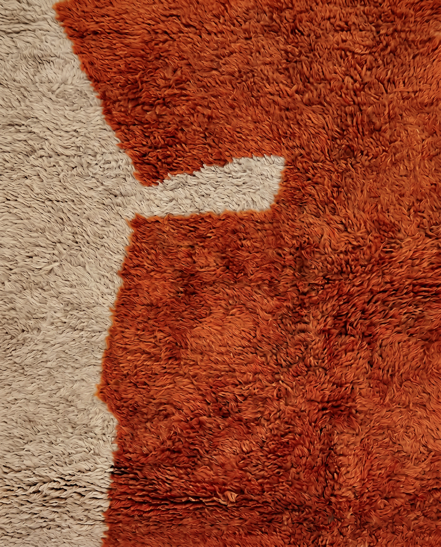 DIMA Beni Ourain rust abstract color block Moroccan rug close-up showing hand-knotted wool texture and pile detail, by NURA