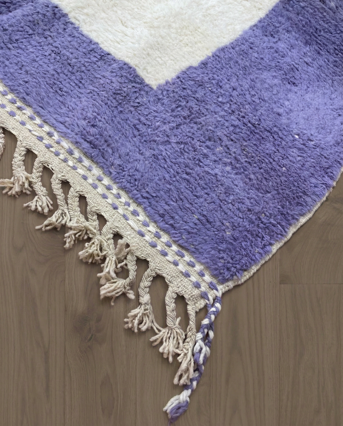 FARAH Beni Ourain ivory solid border Moroccan rug close-up of hand-tied fringe and kilim band detail, by NURA
