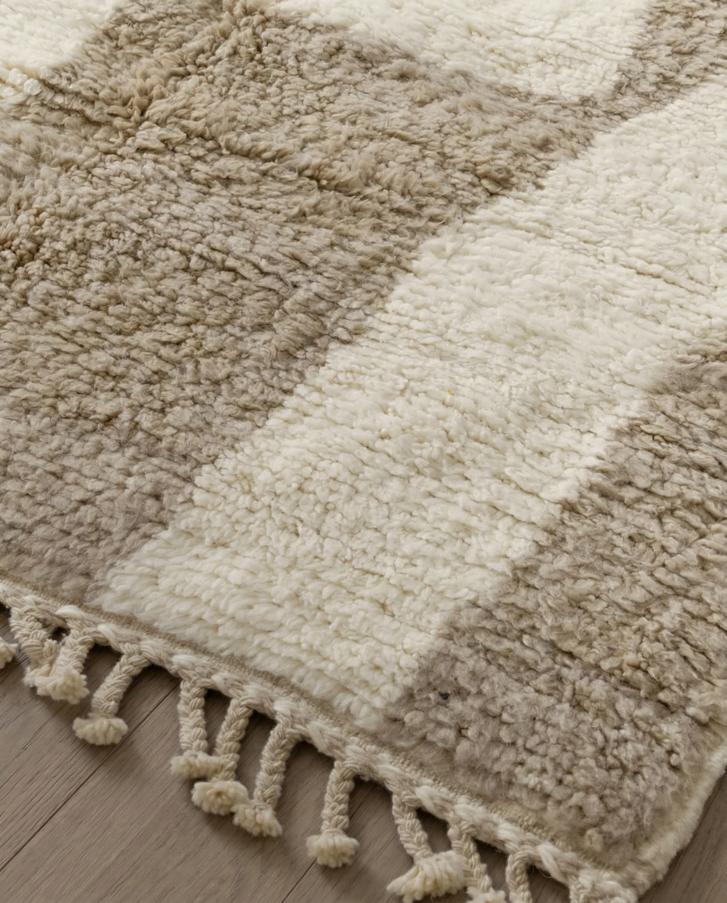 KARIMA Beni Ourain cream abstract geometric blocks Moroccan rug close-up of hand-tied fringe and kilim band detail, by NURA