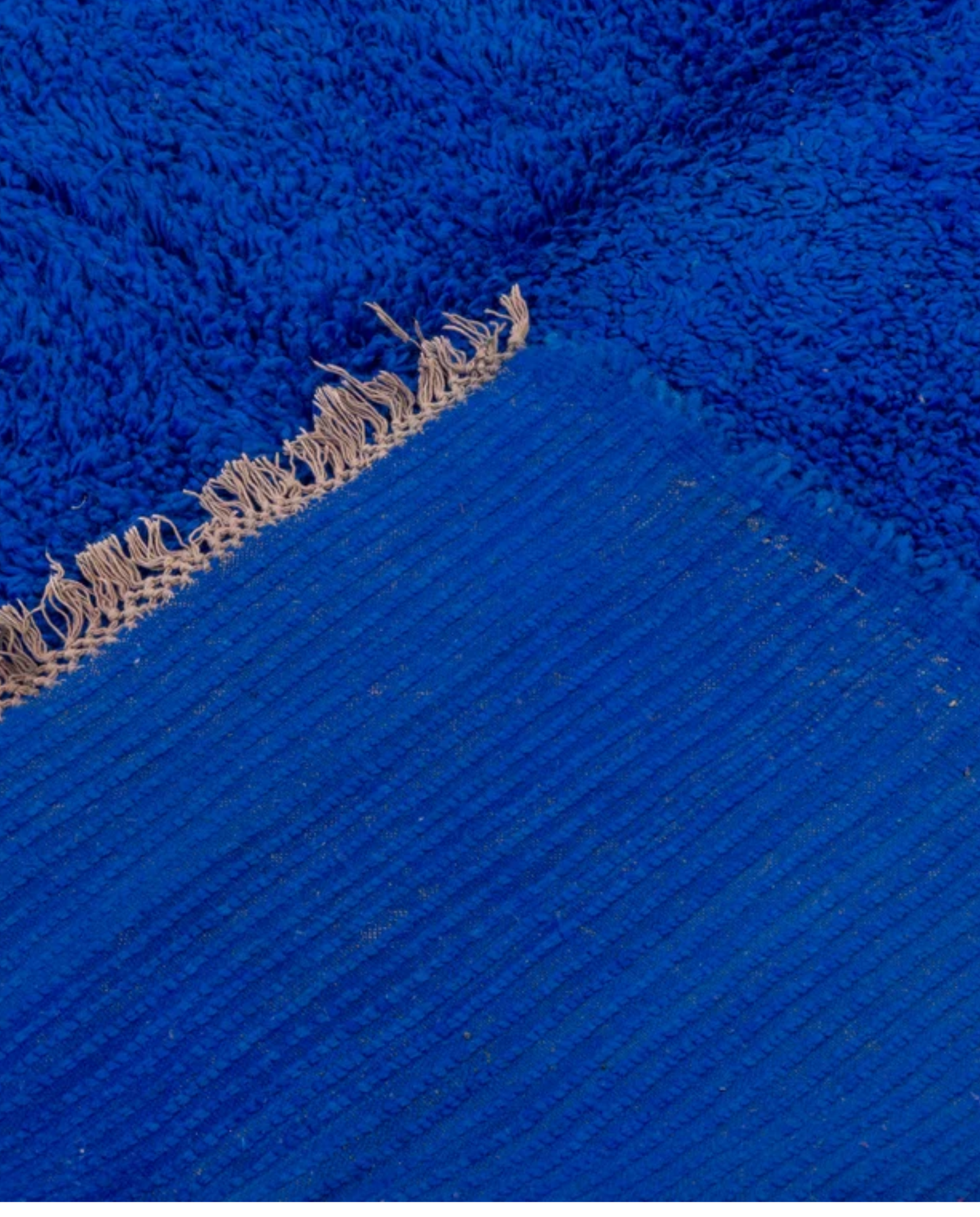 RAJA Mrirt cobalt solid open field Moroccan rug back view showing traditional handwoven construction, by NURA