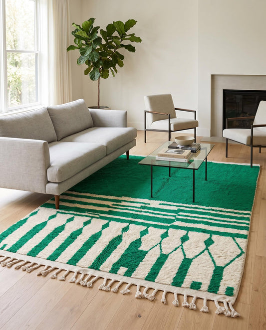 A vibrant green and cream geometric Moroccan rug adds a bold, plush foundation to a modern living room setting by NURA.