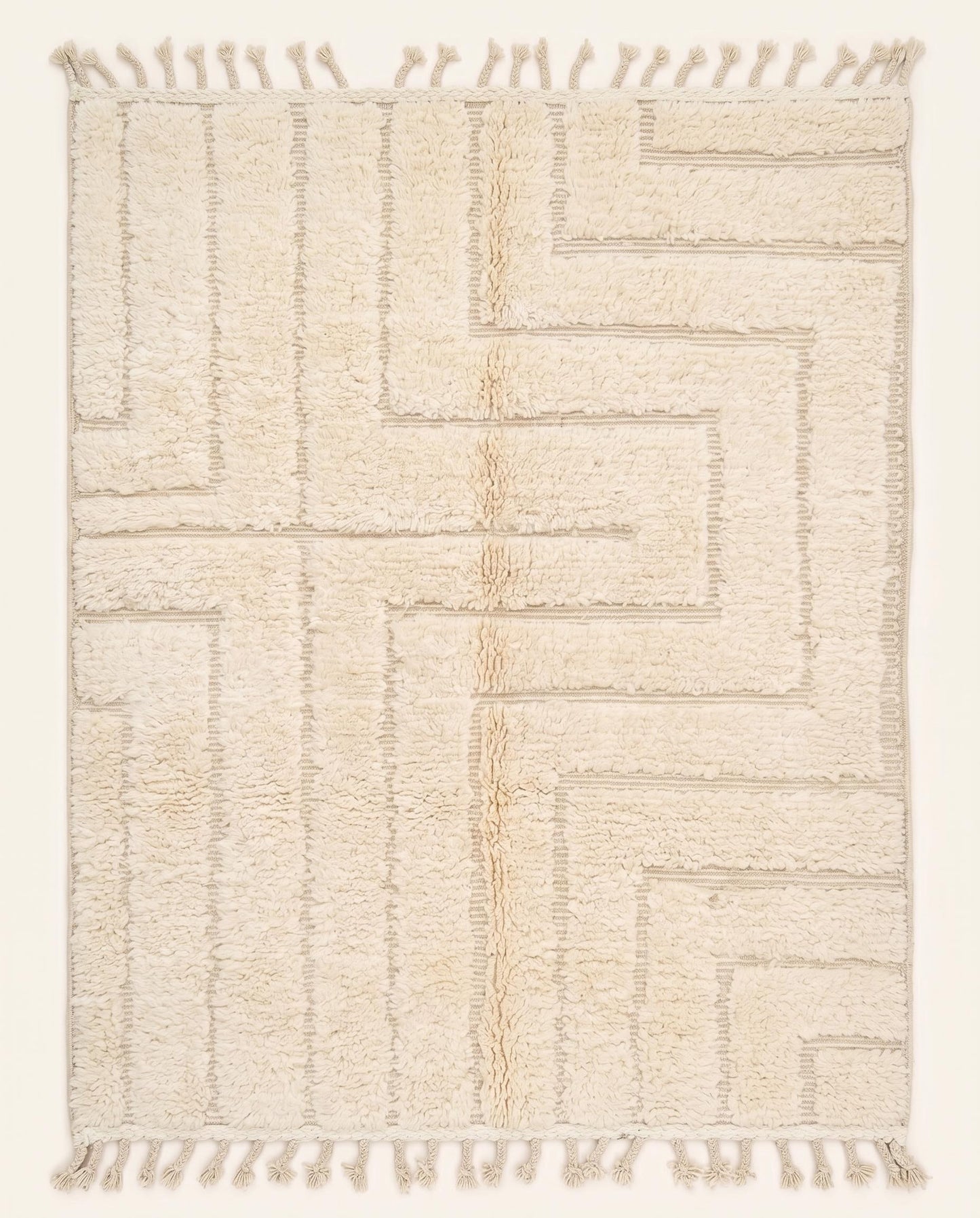 A contemporary Moroccan rug featuring a sculptural high-low geometric maze pattern in solid cream wool, crafted by NURA.