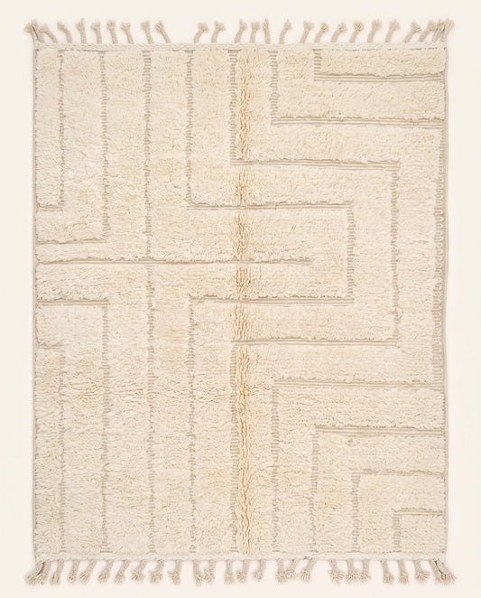 A contemporary Moroccan rug featuring a sculptural high-low geometric maze pattern in solid cream wool, crafted by NURA.