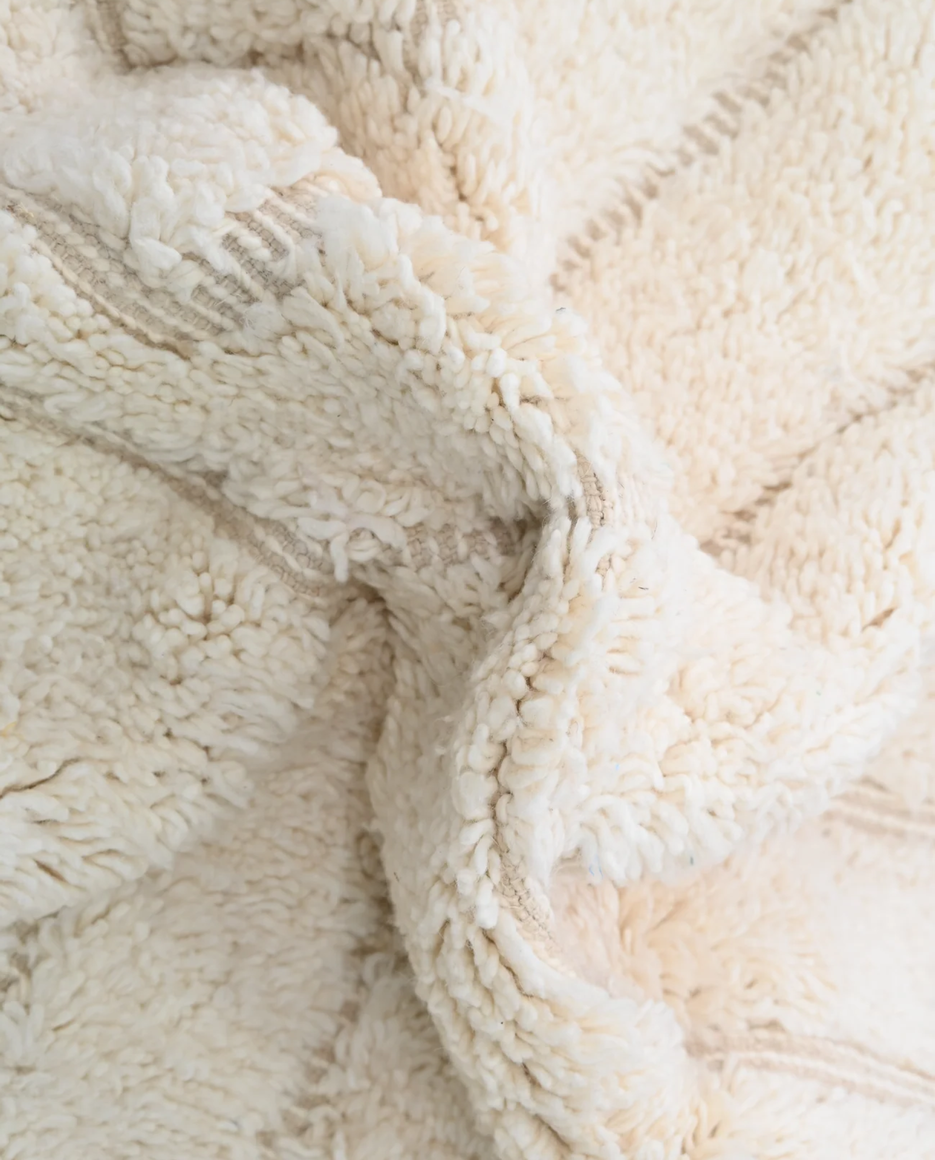 ABLA Beni Ourain cream geometric maze Moroccan rug close-up showing hand-knotted wool texture and pile detail 2, by NURA