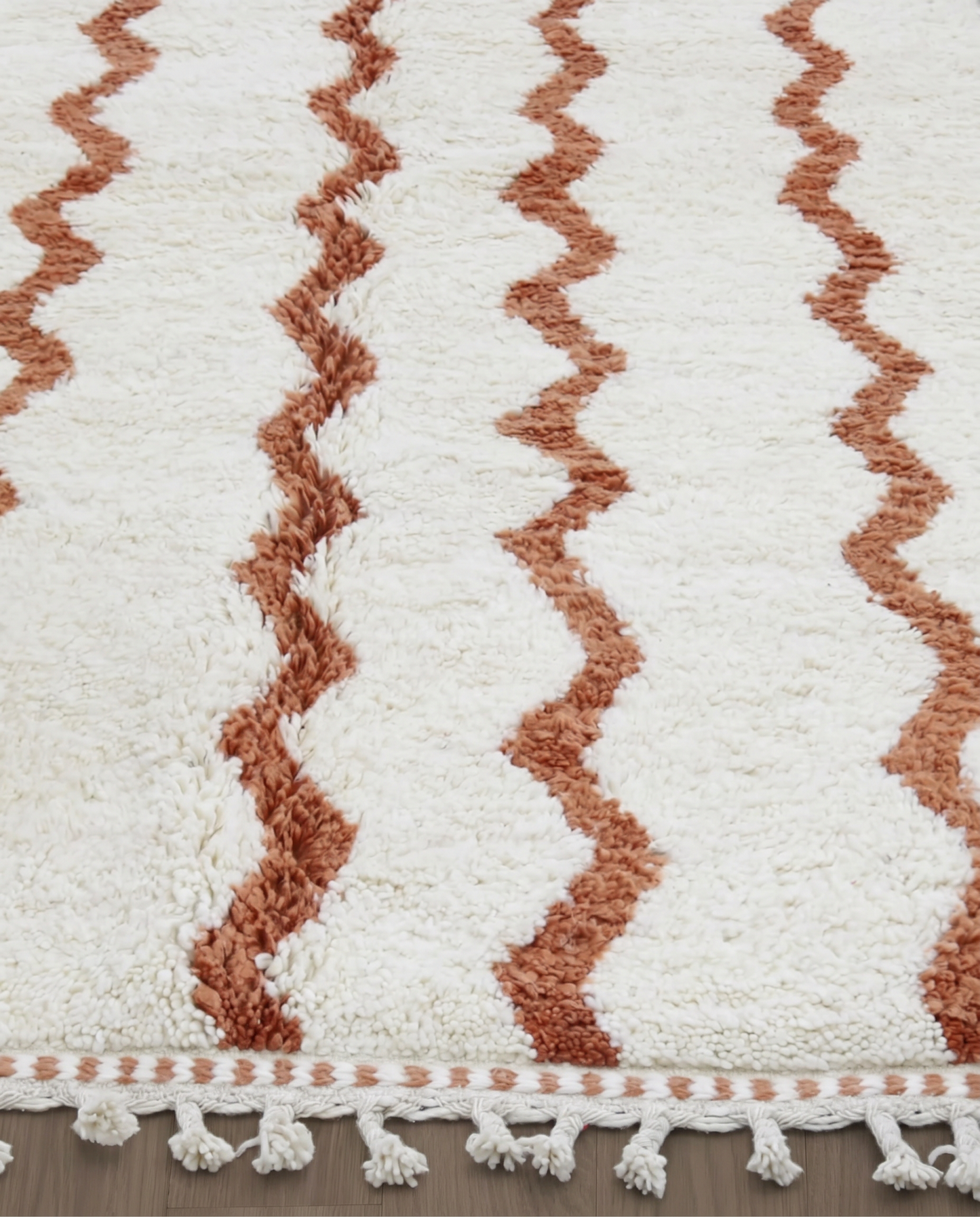 AFARA Beni Ourain cream wavy striped field Moroccan rug close-up of hand-tied fringe and kilim band detail, by NURA