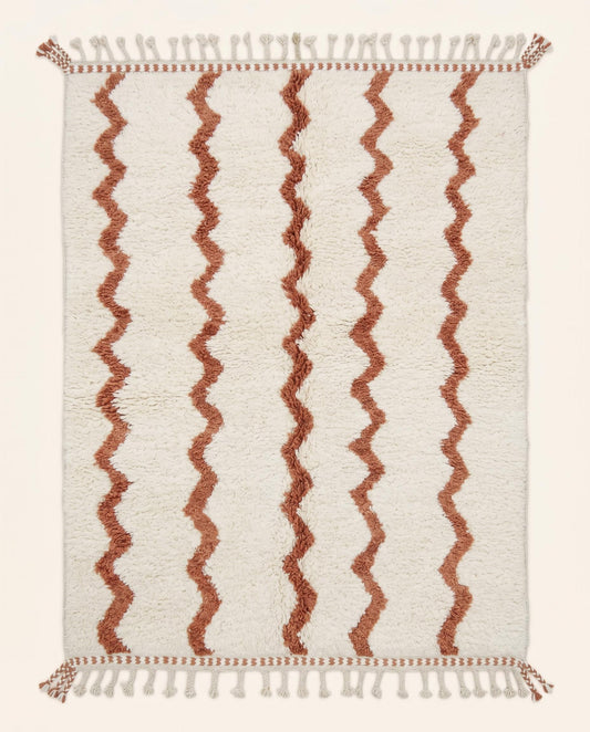 Hand-knotted Beni Ourain Moroccan rug featuring a plush cream wool pile with vertical wavy terracotta lines, by NURA.
