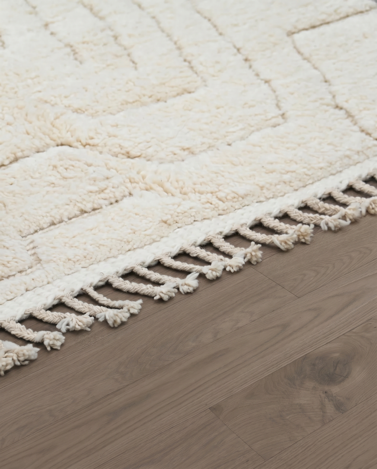 AFRAH Beni Ourain cream organic abstract Moroccan rug close-up of hand-tied fringe and kilim band detail 1, by NURA