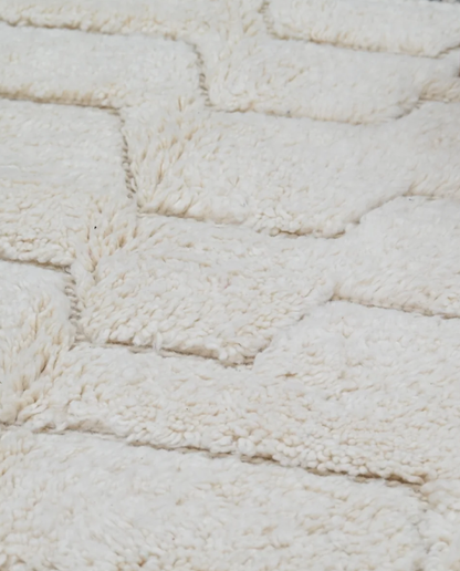AFRAH Beni Ourain cream organic abstract Moroccan rug close-up showing hand-knotted wool texture and pile detail 1, by NURA