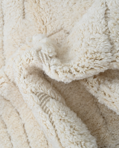 AFRAH Beni Ourain cream organic abstract Moroccan rug close-up showing hand-knotted wool texture and pile detail 2, by NURA