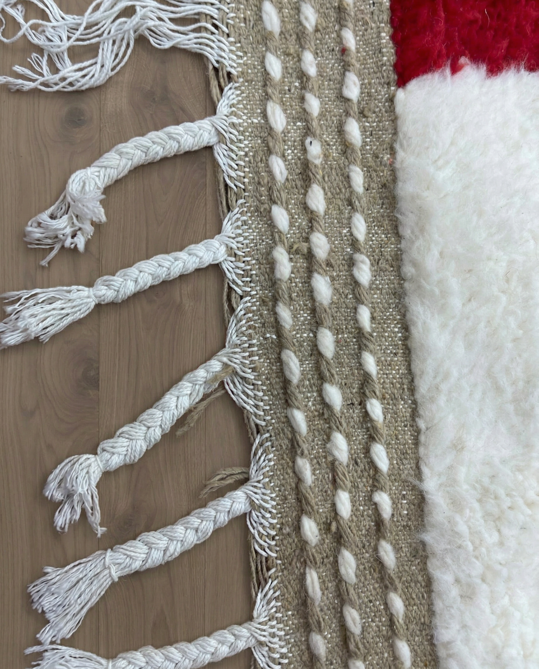 AICHA Beni Ourain ivory abstract color block Moroccan rug close-up of hand-tied fringe and kilim band detail, by NURA