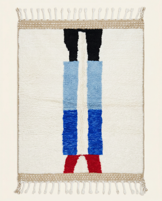 Plush ivory Beni Ourain Moroccan rug with a bold abstract color block design in cobalt blue, red, and black, by NURA.