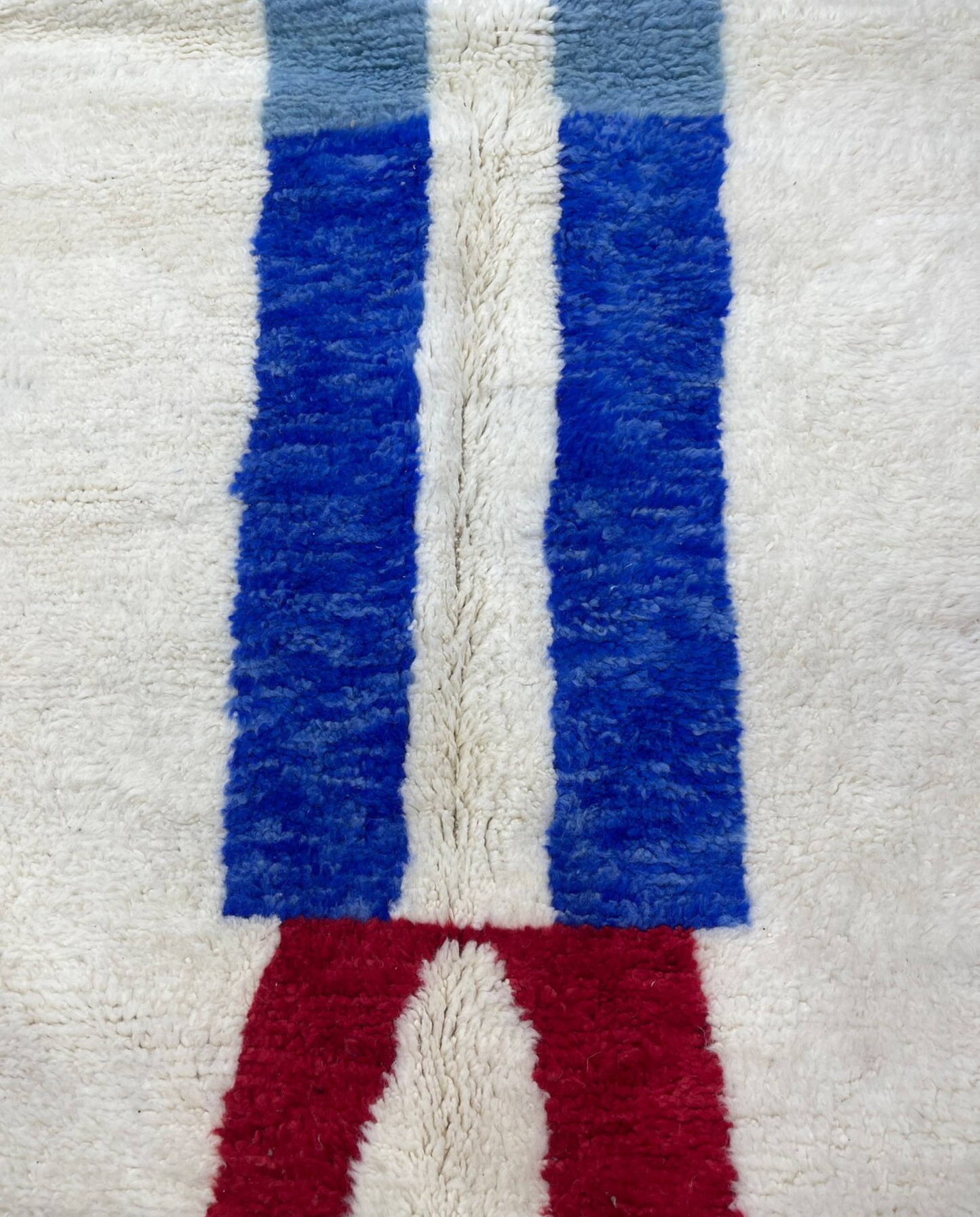 AICHA Beni Ourain ivory abstract color block Moroccan rug close-up showing hand-knotted wool texture and pile detail 2, by NURA