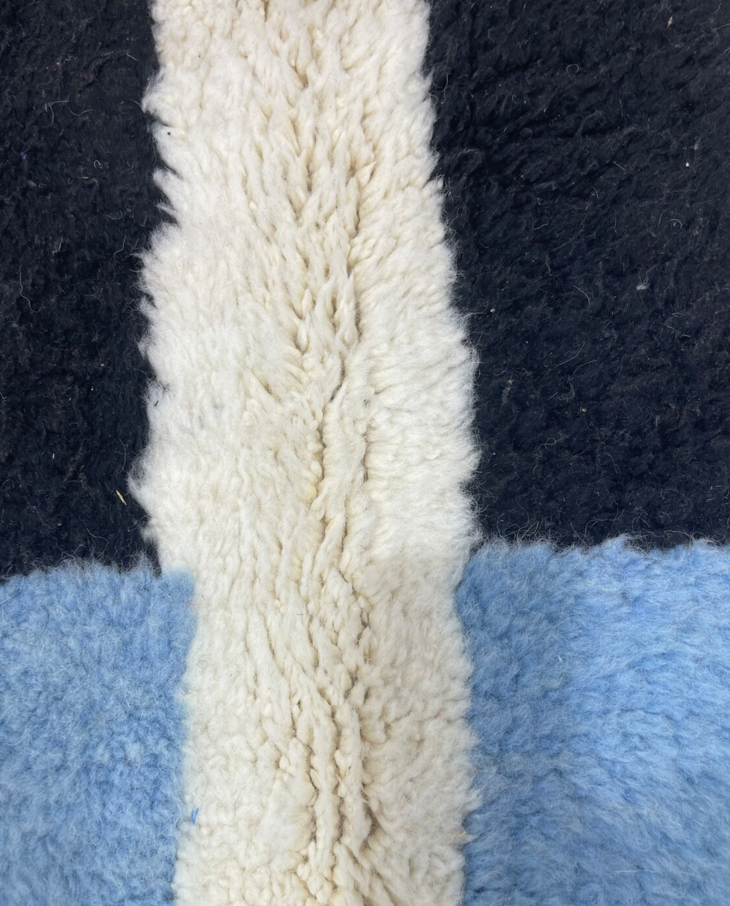 AICHA Beni Ourain ivory abstract color block Moroccan rug close-up showing hand-knotted wool texture and pile detail, by NURA