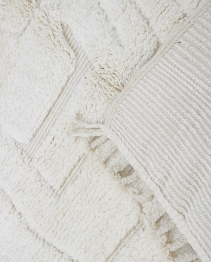 AKILA Beni Ourain cream organic abstract Moroccan rug close-up of hand-tied fringe and kilim band detail, by NURA