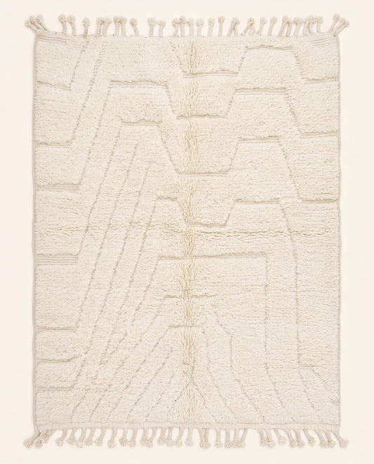A plush cream Beni Ourain Moroccan rug featuring a subtle carved geometric design in a tonal monochromatic palette by NURA.