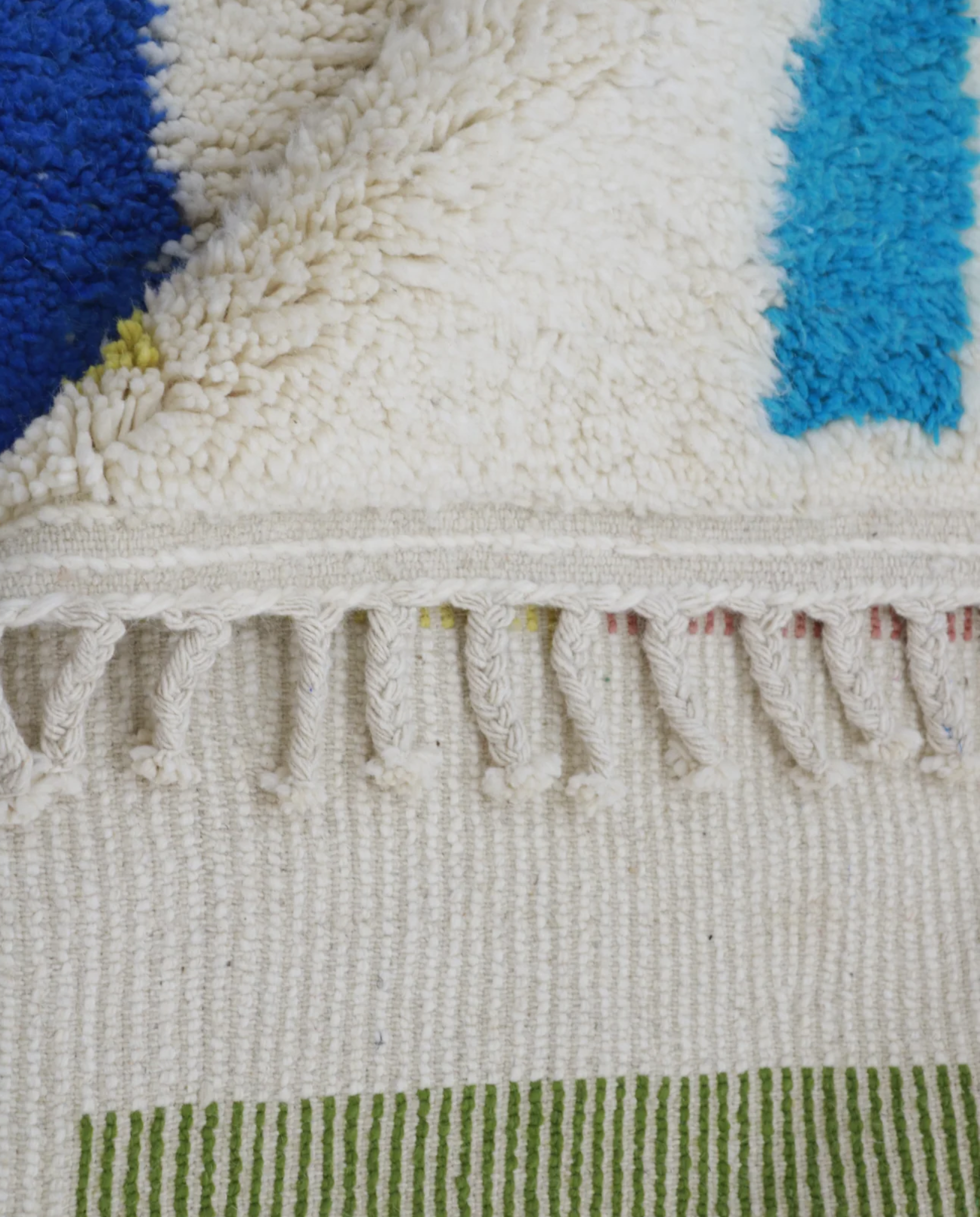 ALIMA Azilal cream organic abstract Moroccan rug close-up of hand-tied fringe and kilim band detail, by NURA