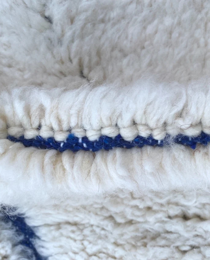 AMAL Beni Ourain cream diamond lattice Moroccan rug close-up showing hand-knotted wool texture and pile detail 1, by NURA