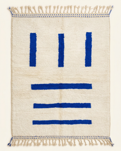 Plush ivory Beni Ourain Moroccan rug with bold cobalt blue linear stripes and a thick high pile, by NURA.
