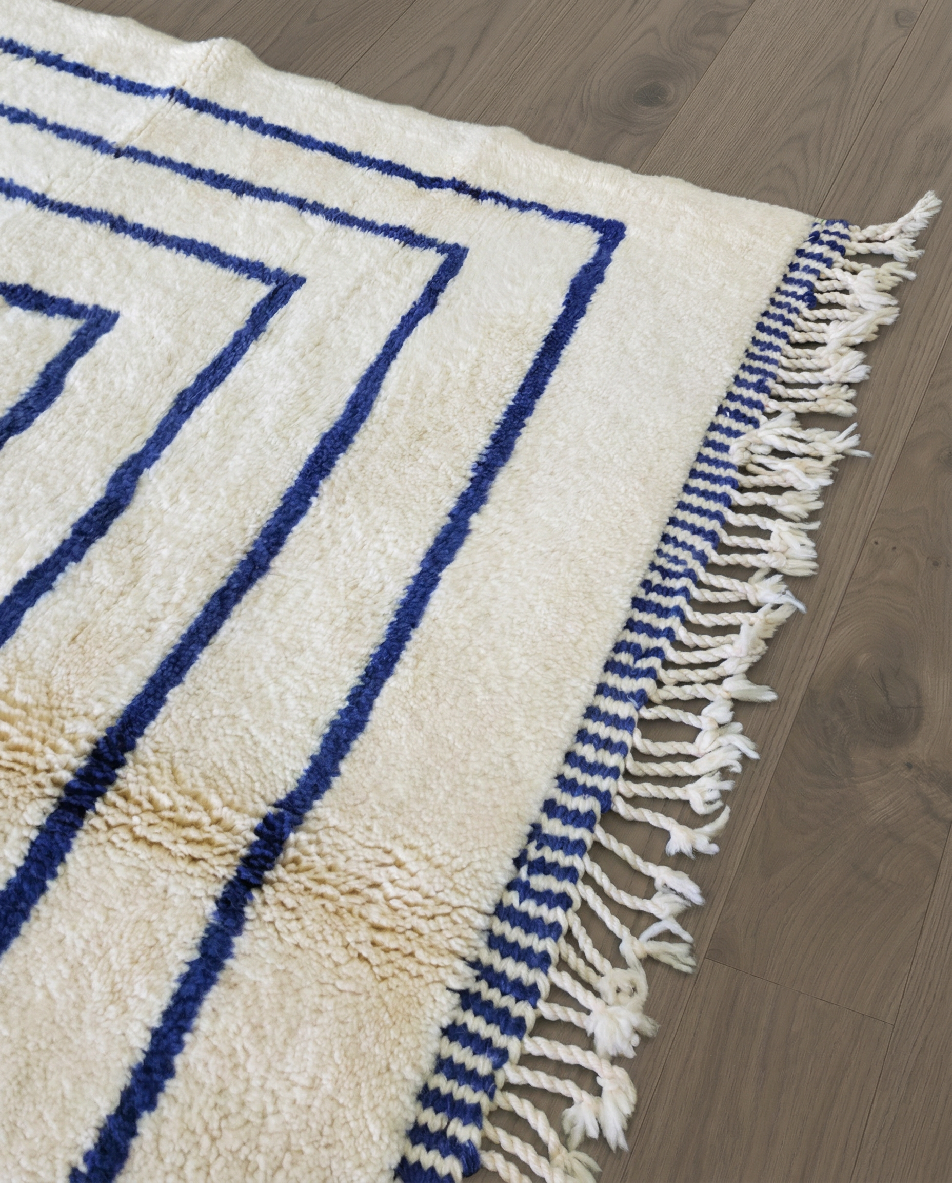 AMINA Beni Ourain cream nested border medallion Moroccan rug close-up of hand-tied fringe and kilim band detail 2, by NURA