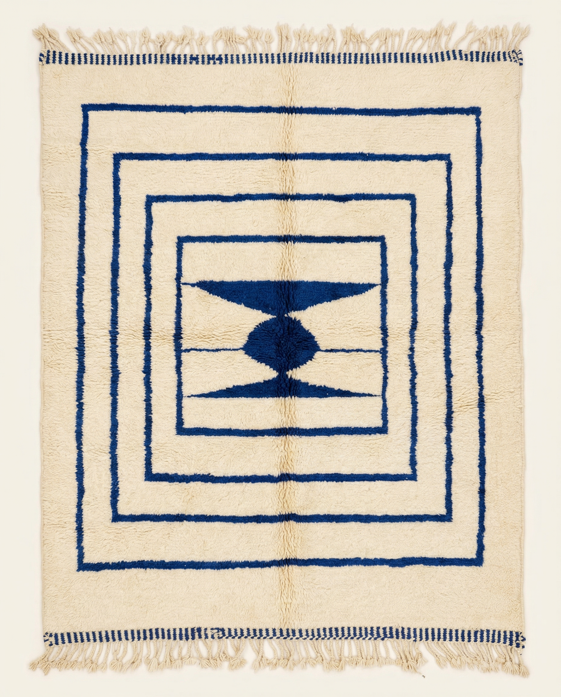 Plush cream Beni Ourain Moroccan rug with bold navy nested borders and a central geometric medallion, by NURA.