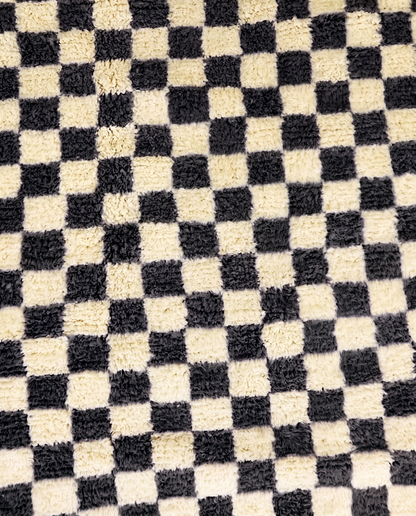 ANISSA Beni Ourain black checkerboard grid Moroccan rug close-up showing hand-knotted wool texture and pile detail 1, by NURA