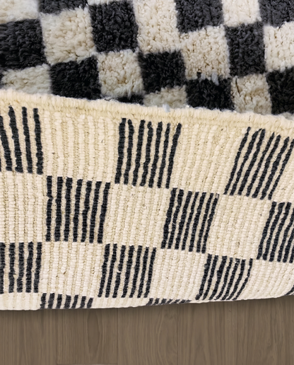 ANISSA Beni Ourain black checkerboard grid Moroccan rug close-up showing hand-knotted wool texture and pile detail 2, by NURA