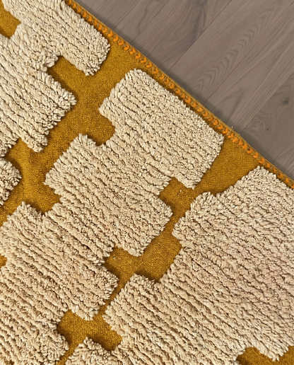 ARWA Beni Ourain mustard stepped columns Moroccan rug close-up of hand-tied fringe and kilim band detail, by NURA