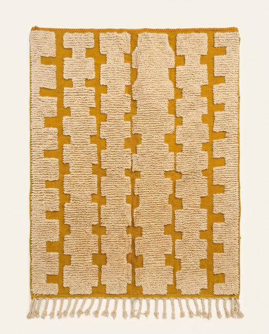 A custom mustard yellow Beni Ourain Moroccan rug by NURA featuring raised cream wool stepped columns on a flatwoven ground.