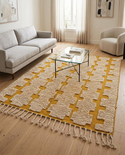 The mustard yellow and cream mixed-pile Moroccan rug by NURA styled in a modern living room with warm natural light.