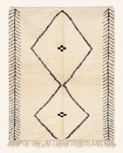 Plush cream Beni Ourain Moroccan rug with a large black double diamond motif and herringbone end bands, by NURA.
