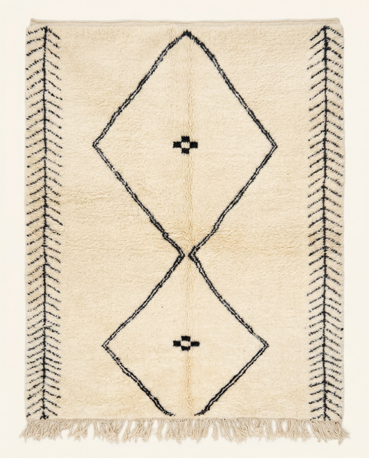 Plush cream Beni Ourain Moroccan rug with a large black double diamond motif and herringbone end bands, by NURA.