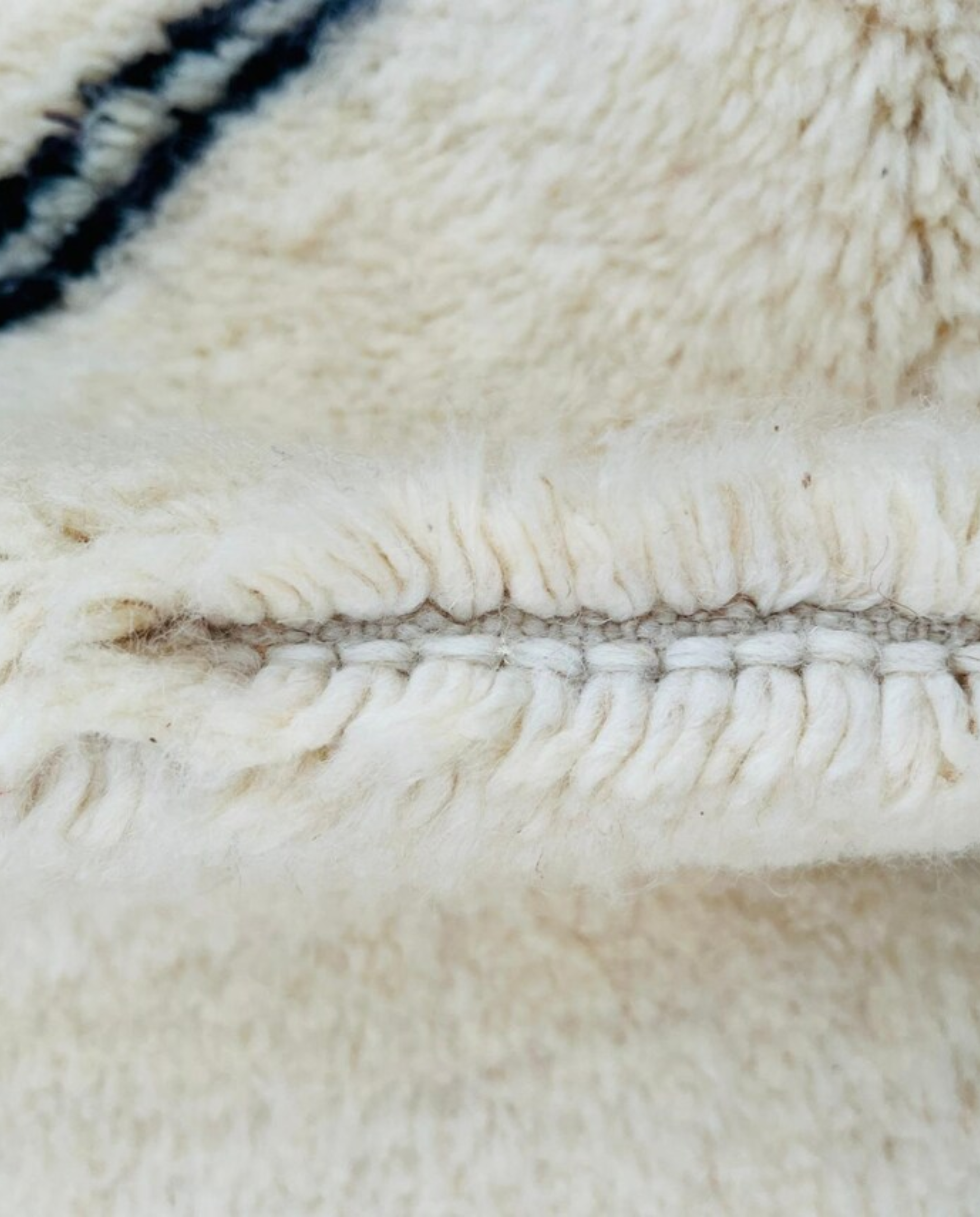 ASMA Beni Ourain cream central double diamond Moroccan rug close-up showing hand-knotted wool texture and pile detail 2, by NURA