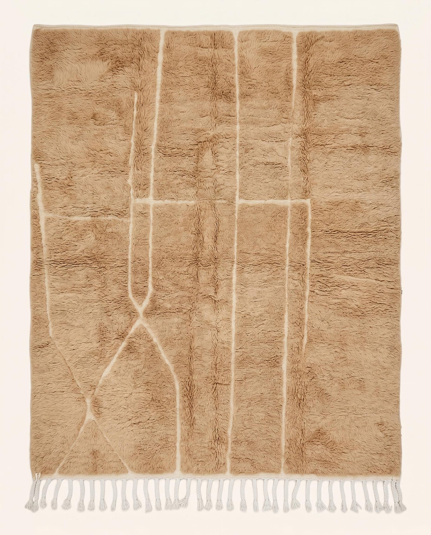 Plush camel Mrirt Moroccan rug featuring a solid field with subtle carved geometric lines, hand-knotted in soft wool by NURA.