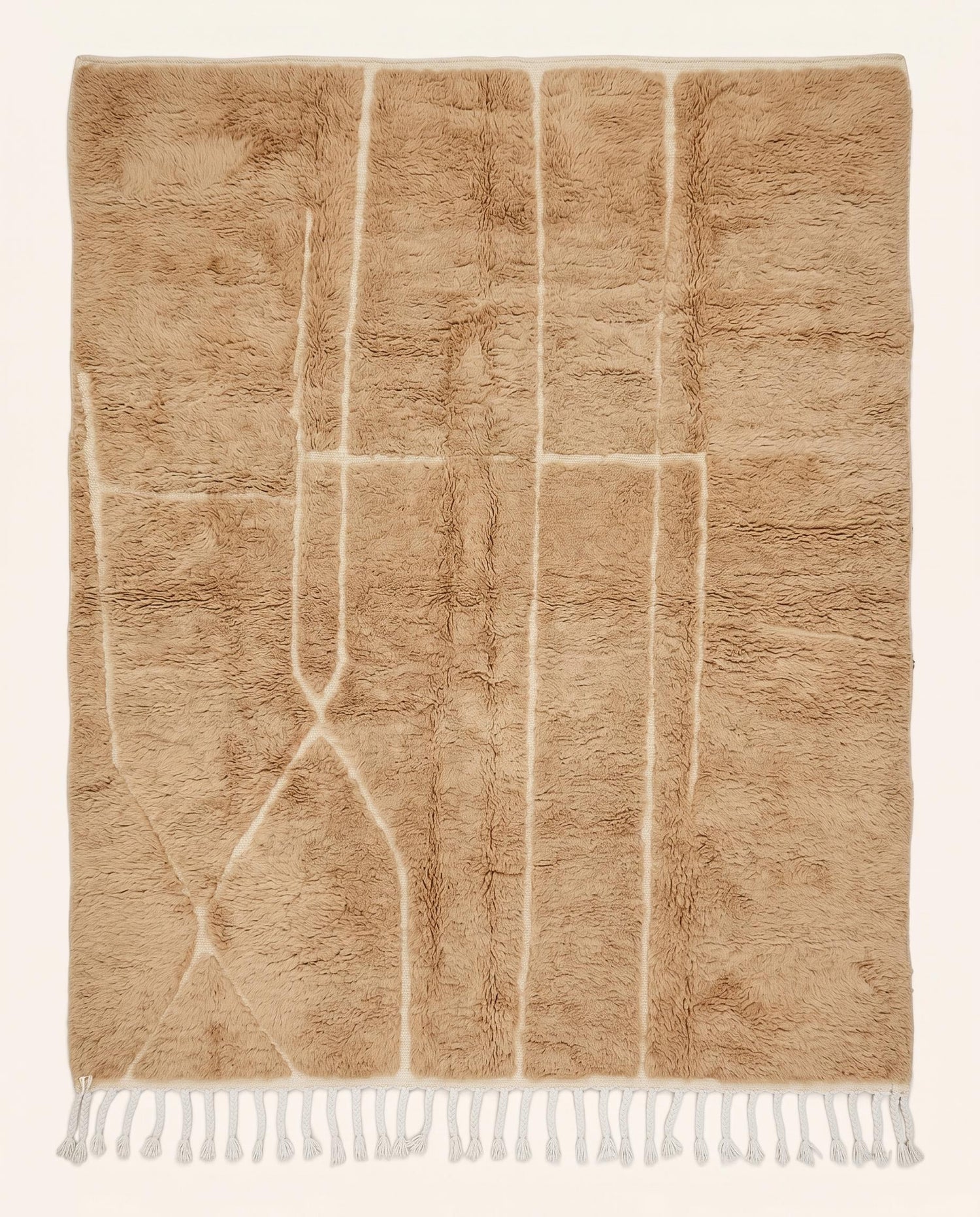 Plush camel Mrirt Moroccan rug featuring a solid field with subtle carved geometric lines, hand-knotted in soft wool by NURA.