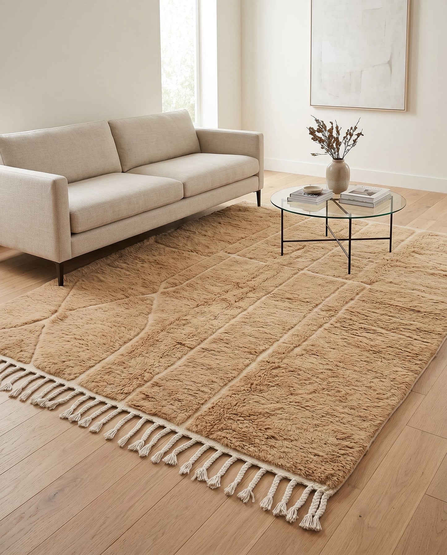 A plush camel Mrirt Moroccan rug by NURA anchors a modern living room, its carved geometric texture adding warmth and depth.