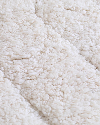 AYA Beni Ourain cream carved linear grid Moroccan rug close-up showing hand-knotted wool texture and pile detail 2, by NURA