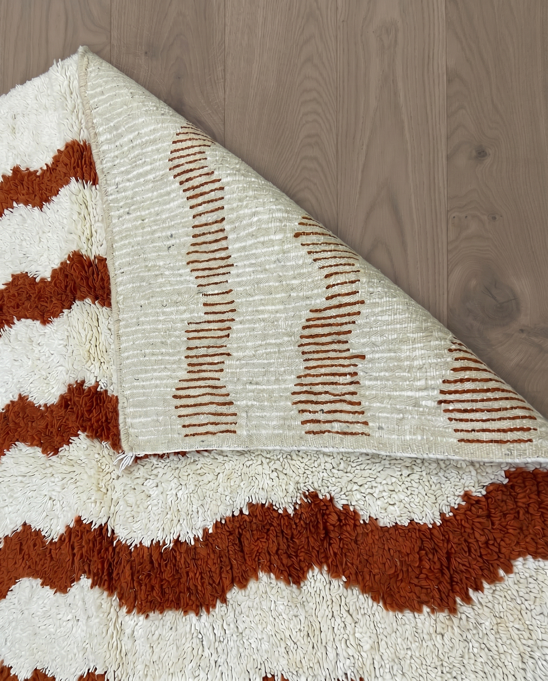 AZIZA Beni Ourain cream wavy stripes Moroccan rug back view showing traditional handwoven construction, by NURA