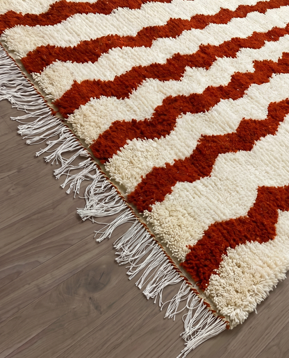 AZIZA Beni Ourain cream wavy stripes Moroccan rug close-up of hand-tied fringe and kilim band detail, by NURA