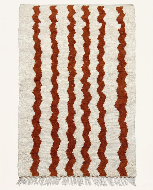 Plush Beni Ourain Moroccan wool rug by NURA featuring dynamic rust wavy stripes across a thick cream field.