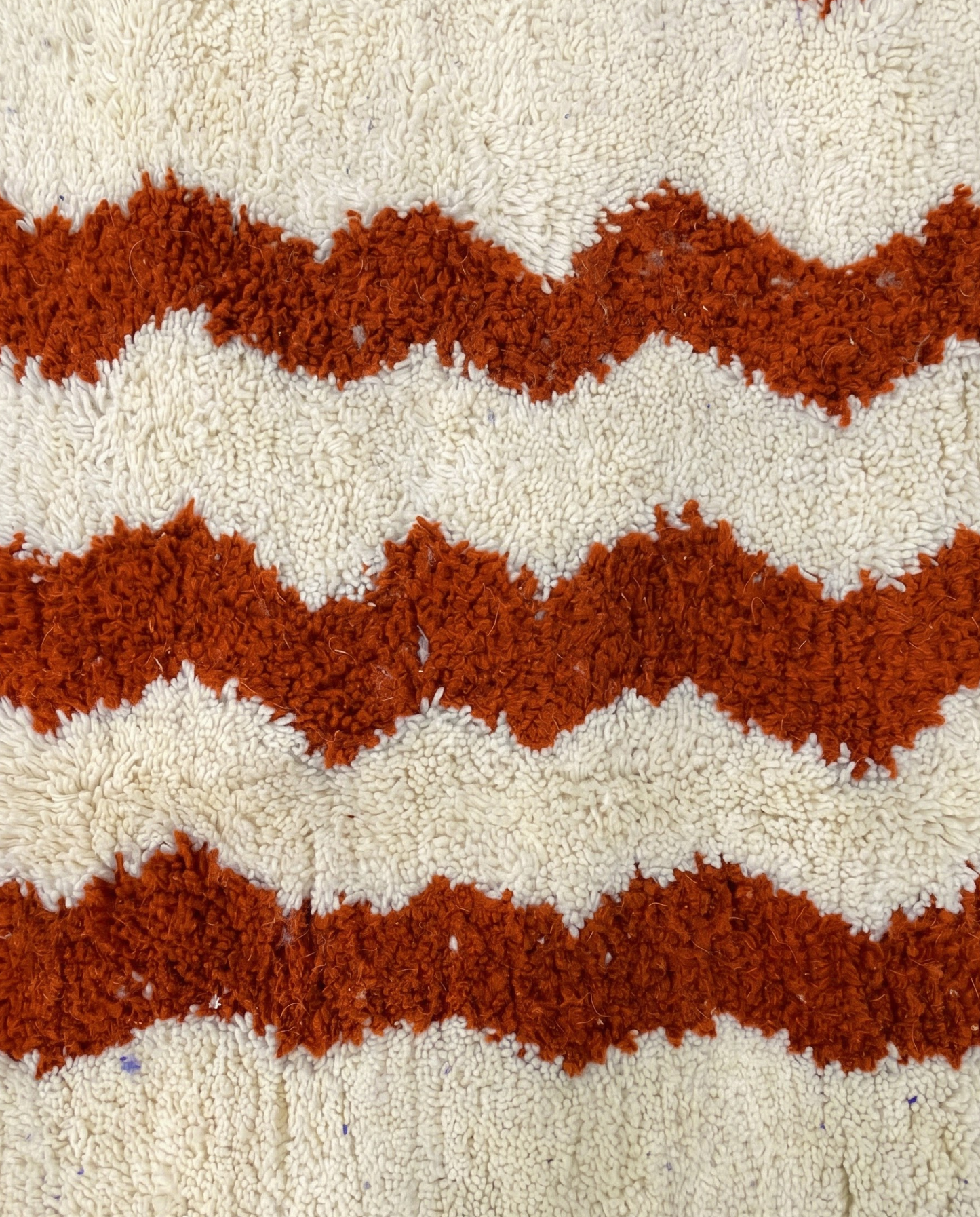 AZIZA Beni Ourain cream wavy stripes Moroccan rug close-up showing hand-knotted wool texture and pile detail, by NURA