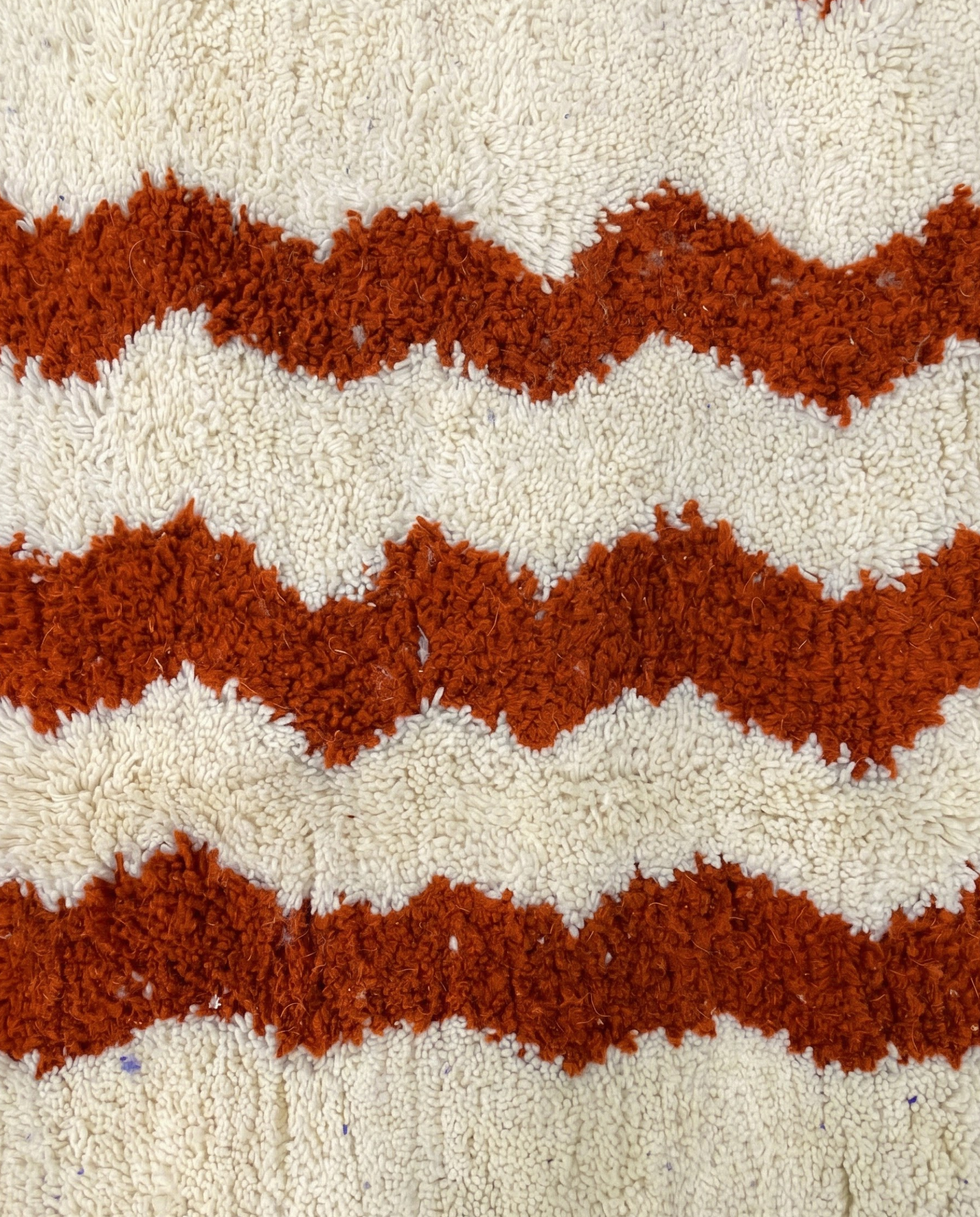 AZIZA Beni Ourain cream wavy stripes Moroccan rug close-up showing hand-knotted wool texture and pile detail, by NURA