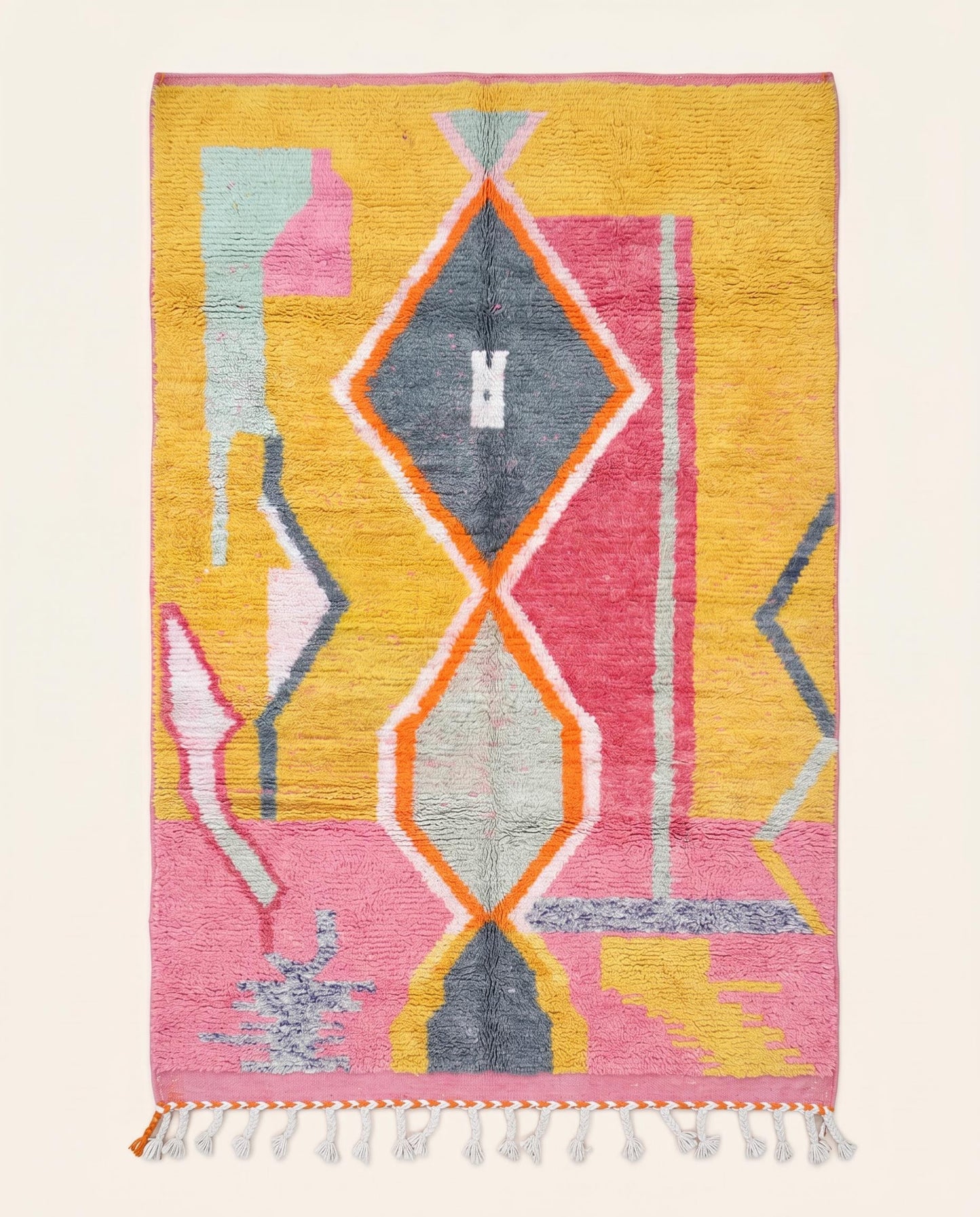 Vibrant Moroccan Azilal rug featuring a bold abstract geometric pattern in mustard yellow, pink, and orange by NURA.