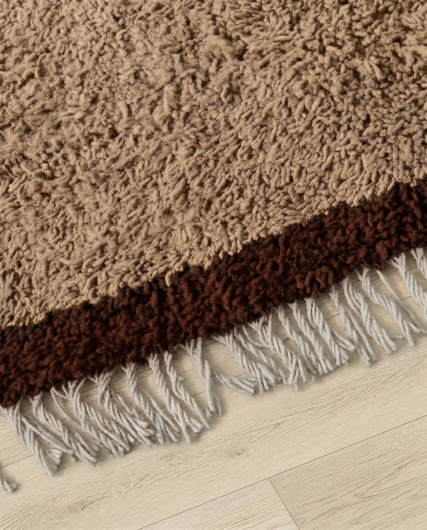BAYA Beni Ourain tan bordered field Moroccan rug close-up of hand-tied fringe and kilim band detail, by NURA