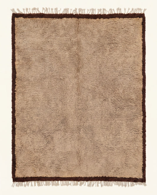 Plush tan Beni Ourain Moroccan rug featuring a thick chocolate brown border, hand-knotted from virgin wool by NURA.