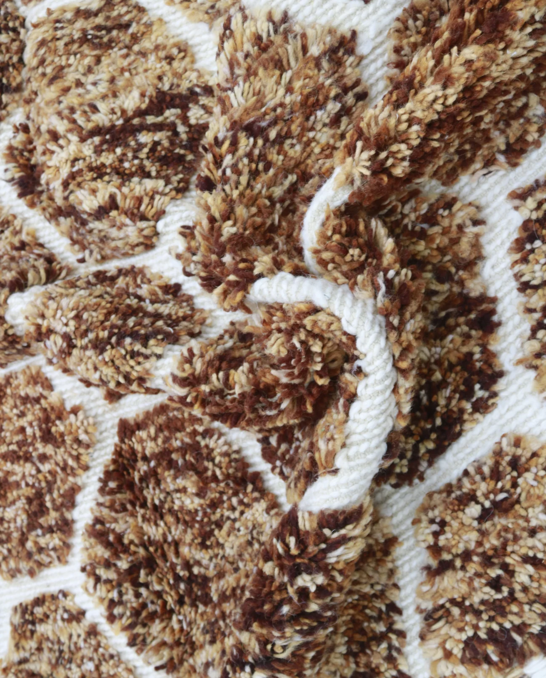 BIA Azilal brown geometric lattice Moroccan rug close-up showing hand-knotted wool texture and pile detail, by NURA