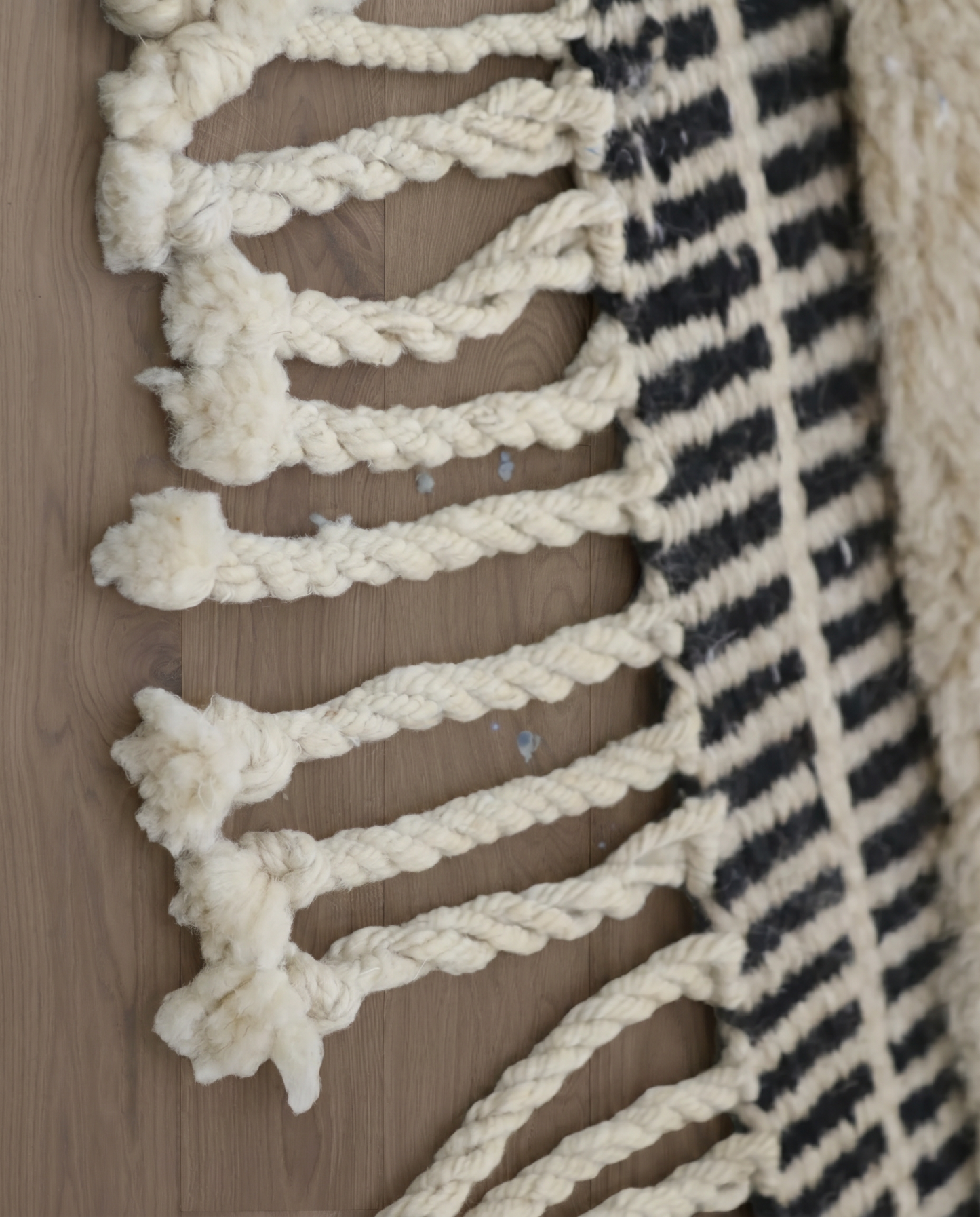 BINA Mrirt cream diamond lattice Moroccan rug close-up of hand-tied fringe and kilim band detail, by NURA